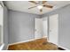 A simple bedroom features gray walls, ceiling fan, and a window for natural light at 214 W Elbert St, Indianapolis, IN 46217
