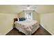 A comfortable bedroom featuring a dormer window, hardwood floors, and a ceiling fan at 214 W Elbert St, Indianapolis, IN 46217