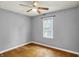 Cozy bedroom featuring a ceiling fan, a window, and wood floors, perfect for relaxation at 214 W Elbert St, Indianapolis, IN 46217