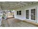 Spacious wooden deck featuring white railings, a hot tub, and french doors at 214 W Elbert St, Indianapolis, IN 46217