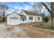 Charming home with a one-car garage and a bright yellow front door at 214 W Elbert St, Indianapolis, IN 46217