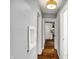 Hallway featuring wood floors, neutral walls, a display cutout, and an open view to the kitchen at 214 W Elbert St, Indianapolis, IN 46217