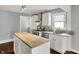Modern kitchen featuring a butcher block island, stainless steel appliances, and light granite countertops at 214 W Elbert St, Indianapolis, IN 46217