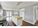 Open kitchen featuring a butcher block island, stainless steel appliances, and an open concept to the living room at 214 W Elbert St, Indianapolis, IN 46217