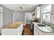 Bright kitchen with white cabinets, stainless steel appliances, light countertops, and wood floors at 214 W Elbert St, Indianapolis, IN 46217