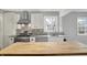 White kitchen with a butcher block island, stainless steel appliances, and granite countertops at 214 W Elbert St, Indianapolis, IN 46217