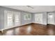 Bright living room with hardwood floors, a large window, french doors, and a built-in cabinet at 214 W Elbert St, Indianapolis, IN 46217