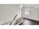 A modern stairway with white railings, dark wood floors, and a window, showcasing natural light at 214 W Elbert St, Indianapolis, IN 46217