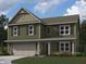 Charming two-story home featuring a covered porch, two-car garage, vertical siding and complementary shutters at 2191 Warbler St, Danville, IN 46122