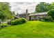 A well-manicured lawn with mature trees and stone accents, creating a serene backyard oasis at 224 Brierley Way, Carmel, IN 46032