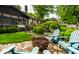 Backyard with firepit, Adirondack chairs, and lush landscaping at 224 Brierley Way, Carmel, IN 46032