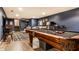 Finished basement with a billiards table, seating area, and stairs at 224 Brierley Way, Carmel, IN 46032