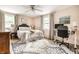 Bright bedroom featuring a ceiling fan and desk with natural light at 224 Brierley Way, Carmel, IN 46032