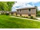 Charming home with manicured lawn, stone accents, and gray siding, offering great curb appeal at 224 Brierley Way, Carmel, IN 46032