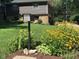 Beautifully landscaped front yard with mature trees and colorful flowers creating a welcoming curb appeal at 224 Brierley Way, Carmel, IN 46032