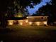 Exterior of a two-story home at night with professional lighting highlighting the architecture and landscaping at 224 Brierley Way, Carmel, IN 46032