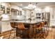 Bright and open kitchen with an island, white cabinets, stainless appliances, and wood accents for a modern feel at 224 Brierley Way, Carmel, IN 46032