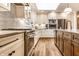 The updated kitchen features modern appliances, a stylish backsplash, and a functional island for cooking at 224 Brierley Way, Carmel, IN 46032