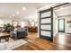 Bright, open-concept living area connects the kitchen and living spaces, featuring wood floors and stylish decor at 224 Brierley Way, Carmel, IN 46032