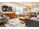 Open living room with modern furniture, connecting to the kitchen with a breakfast bar at 224 Brierley Way, Carmel, IN 46032