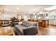 Open living room with modern furniture, connecting to the kitchen with a breakfast bar at 224 Brierley Way, Carmel, IN 46032