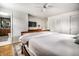 Bright main bedroom featuring a ceiling fan, wood floors, and ensuite bathroom access at 224 Brierley Way, Carmel, IN 46032