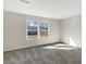 This is an empty, bright room with two large windows looking out into the backyard at 2350 Bridlewood Dr, Franklin, IN 46131