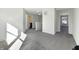 Hallway features neutral walls, plush gray carpet, and lots of natural light from nearby windows, making the walk easy at 2350 Bridlewood Dr, Franklin, IN 46131