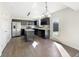 Open concept kitchen with stainless steel appliances, dark cabinetry, and lots of natural light, creating a modern, functional space at 2350 Bridlewood Dr, Franklin, IN 46131