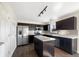 Well-lit kitchen with stainless steel appliances, dark cabinetry, and an island at 2350 Bridlewood Dr, Franklin, IN 46131