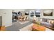 Open-concept living room with gray couch, dining area, and view of the back yard at 2350 Bridlewood Dr, Franklin, IN 46131