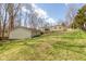 This lovely home boasts a large backyard with a detached garage on a sunny day at 251 Howard Rd, Greenwood, IN 46142