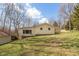 A ranch-style home showcases a lush green yard and complements the light yellow exterior at 251 Howard Rd, Greenwood, IN 46142
