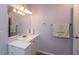 Clean bathroom featuring a single sink, white vanity, a large mirror, and ample lighting at 251 Howard Rd, Greenwood, IN 46142