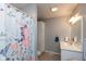 Well-lit bathroom featuring modern vanity, ample storage, and a pretty shower curtain at 251 Howard Rd, Greenwood, IN 46142