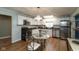 Bright kitchen featuring white cabinets, wood floors, stainless steel appliances, and a dining area at 251 Howard Rd, Greenwood, IN 46142