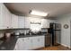 Efficient kitchen with white cabinets, stainless steel appliances, and a double basin sink at 251 Howard Rd, Greenwood, IN 46142