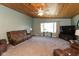 Bright living room featuring a large window, plush carpet, a ceiling fan and comfortable seating at 251 Howard Rd, Greenwood, IN 46142