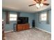 Bedroom with a fan, carpet, dresser, TV, and plenty of natural light from two windows at 251 Howard Rd, Greenwood, IN 46142