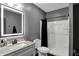 Modern bathroom with gray walls, illuminated mirror, marble vanity, and shower at 2753 Stones Bay Dr, Greenwood, IN 46143