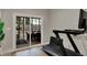 Exercise room with a large sliding glass door overlooking the backyard patio with furniture at 2753 Stones Bay Dr, Greenwood, IN 46143