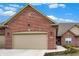 Charming single-Gathering home features a red brick exterior, attached garage, and manicured landscaping at 2753 Stones Bay Dr, Greenwood, IN 46143