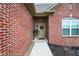 Cozy front porch showcasing a red brick exterior, quaint wreath, and a welcoming entrance at 2753 Stones Bay Dr, Greenwood, IN 46143