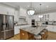 Stylish kitchen featuring white cabinets, stainless steel appliances, and a granite island at 2753 Stones Bay Dr, Greenwood, IN 46143