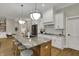Bright kitchen features a large island, granite countertops, and hardwood flooring at 2753 Stones Bay Dr, Greenwood, IN 46143