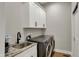 The laundry room features stainless steel appliances and white cabinets at 2753 Stones Bay Dr, Greenwood, IN 46143