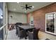 Covered patio features brick accent wall, grill, ceiling fan, and outdoor dining set at 2753 Stones Bay Dr, Greenwood, IN 46143
