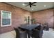View of the covered patio showcases a brick wall and outdoor dining area at 2753 Stones Bay Dr, Greenwood, IN 46143