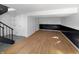 Spacious finished basement with wood-look flooring, black accents and a staircase at 2928 Sheffield Dr, Indianapolis, IN 46229