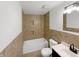 Well-lit bathroom with a tub, toilet, tiled walls, and modern vanity at 2928 Sheffield Dr, Indianapolis, IN 46229